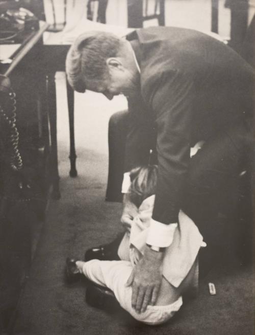 Photograph of President Kennedy Tickling Caroline
