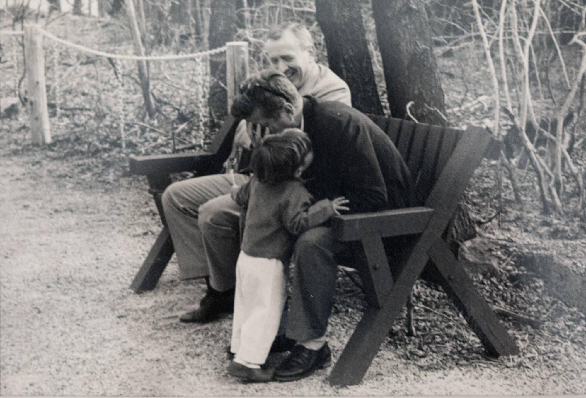 John Jr. Whispering to President Kennedy Seated on Bench – All ...