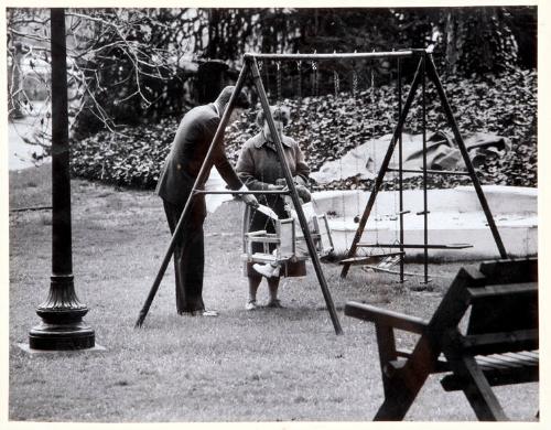 Photograph of John F. Kennedy and John F. Kennedy, Jr. at White House Swing Set