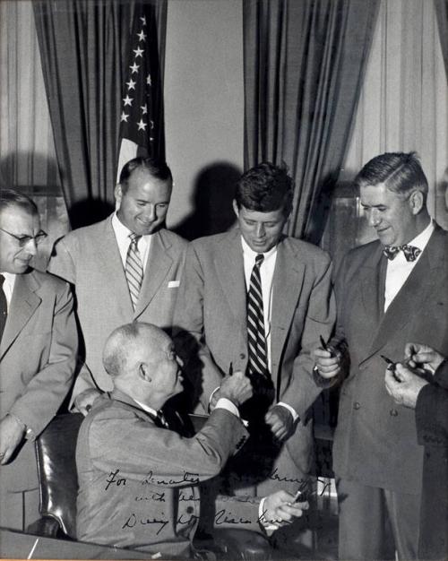 Photograph of John F. Kennedy Receiving Signing Pen from President Eisenhower