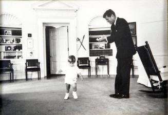 Photograph of John F. Kennedy and John Jr. in Oval Office