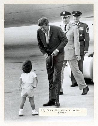 Photograph of President Kennedy Greeted by John F. Kennedy, Jr.