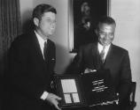 AR7109-K. President John F. Kennedy Receives Gift of stamps (MO 63.3248) from President Sylvanu…